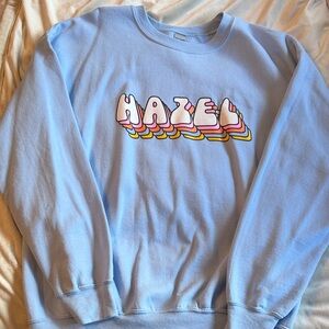 Light Blue Crewneck Sweatshirt with Colorful 'HAZEL' Graphic